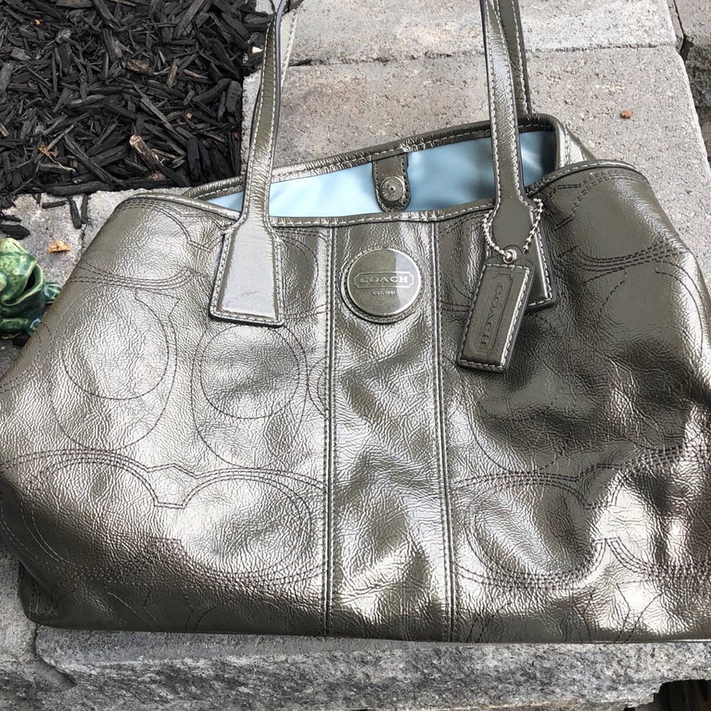 Coach silver bag with multiple compartments.  Some ink marks inside
